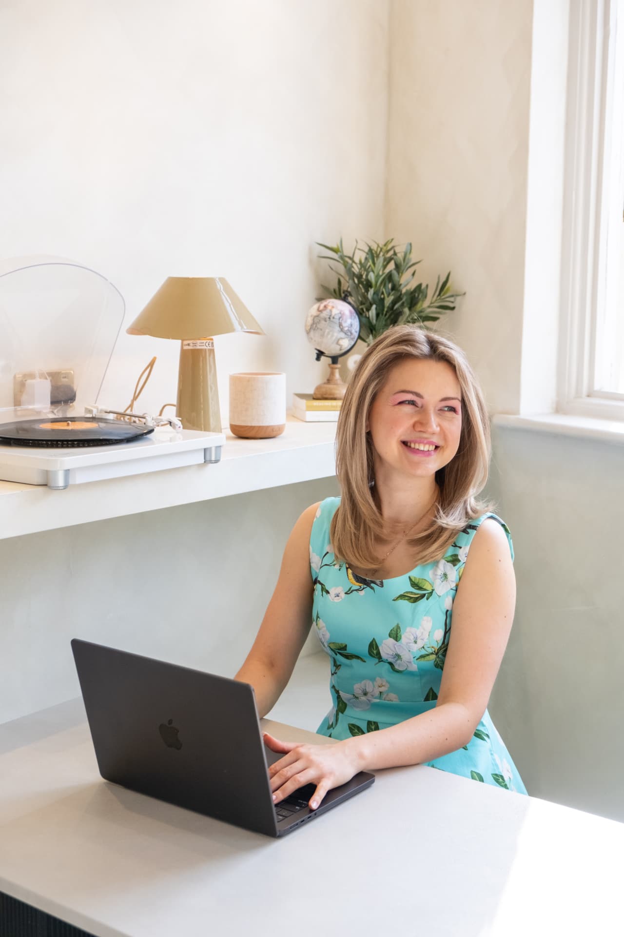 Vendy Steinberga smiling while working at her laptop